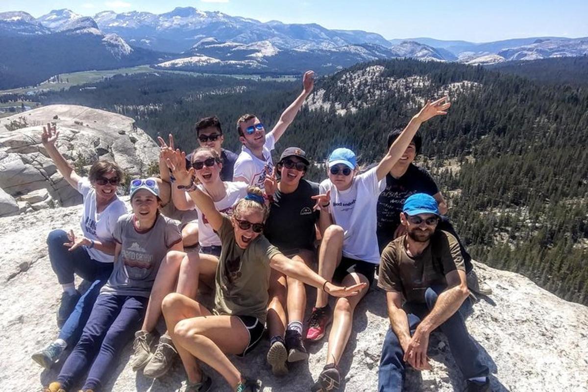 a group of people sitting on top of a mountain