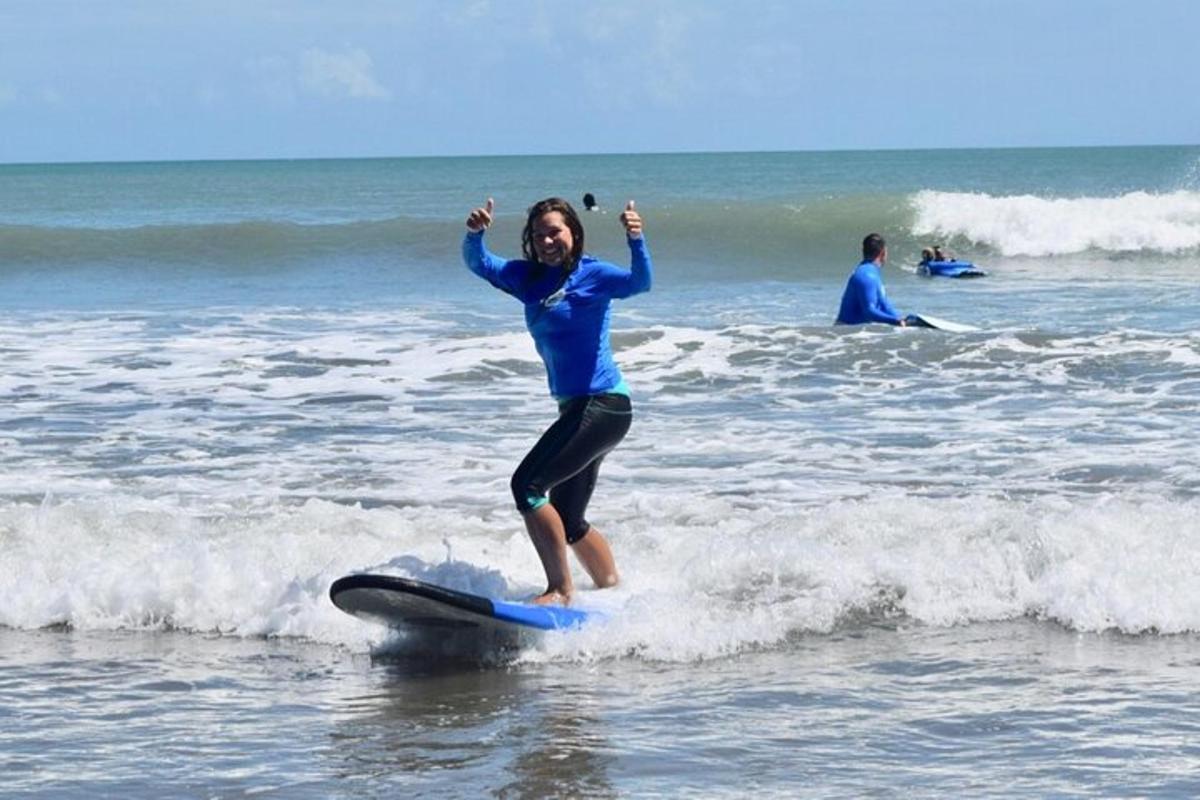 a young girl riding a wave on a surfboard in the ocean