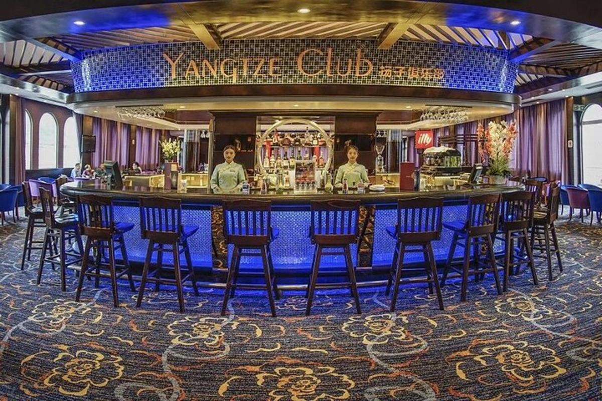 a bar on a cruise ship with people standing behind it