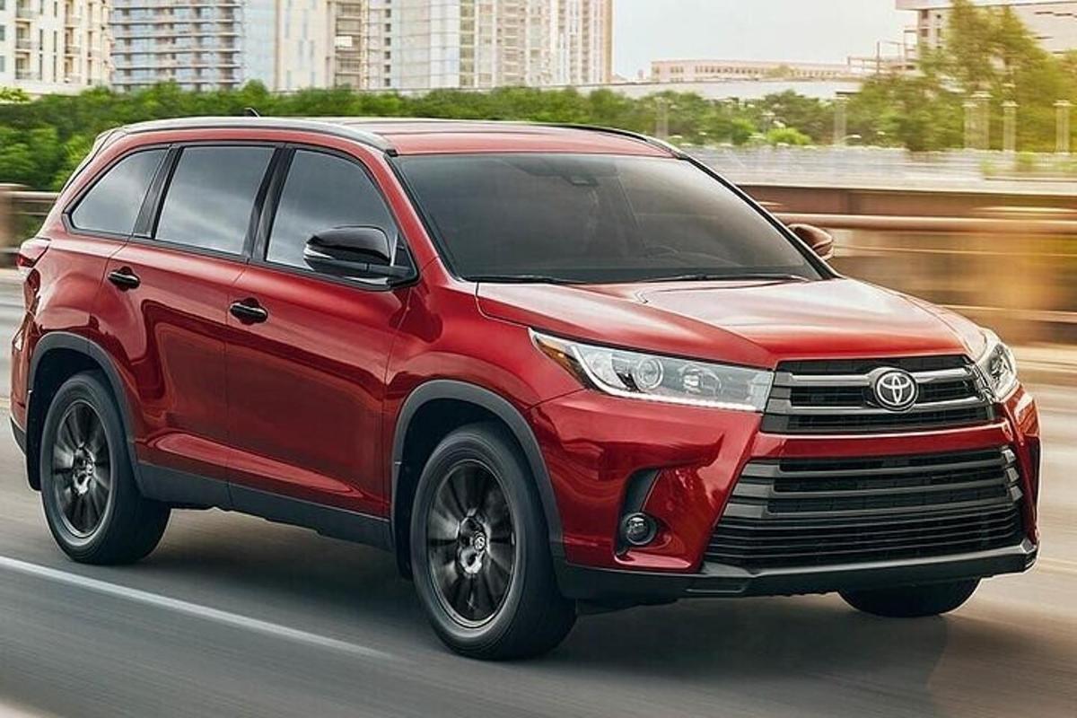 červená Toyota jedoucí po ulici