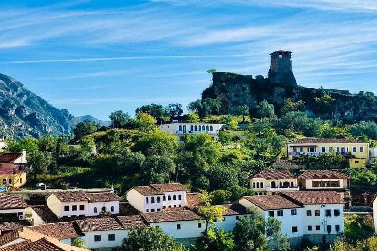 vas na hribu z gradom v ozadju
