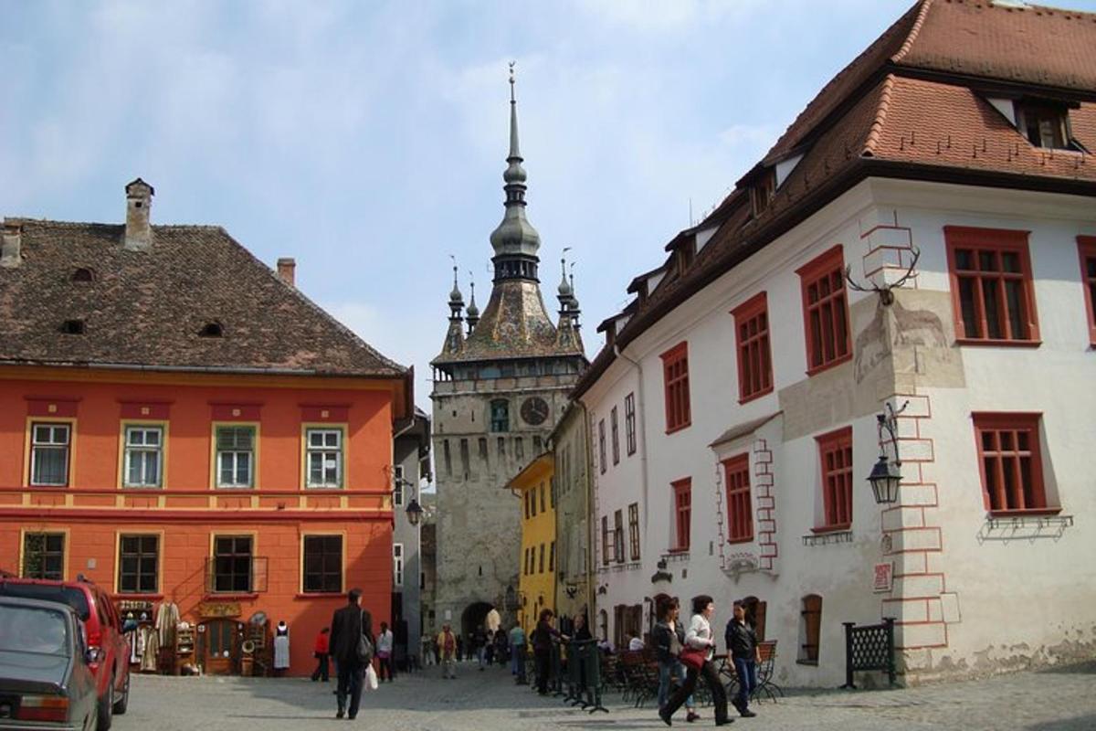 a group of people walking down a street in a city
