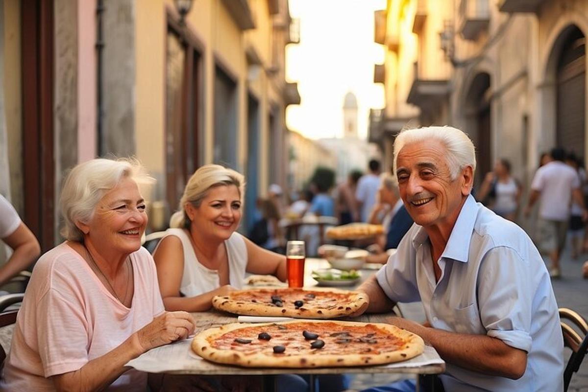 skupina lidí sedících u stolu se dvěma pizzami