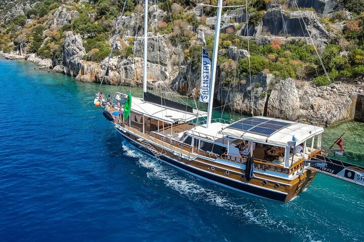 a boat in the water near a cliff