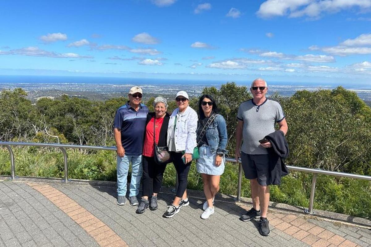 a group of people posing for a picture on a lookout