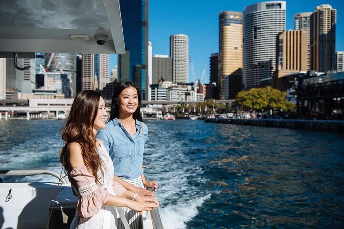 two women are standing on a boat in the water