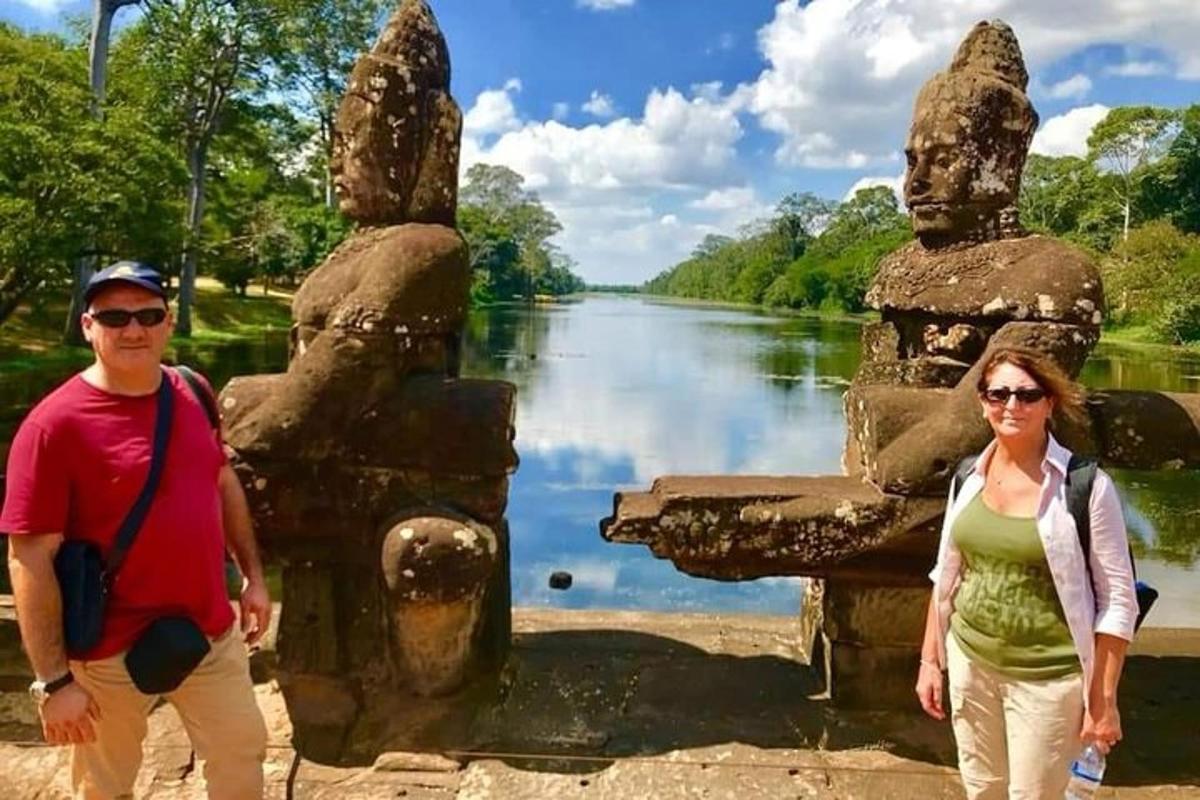 two people standing in front of a body of water