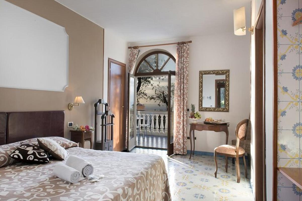 a bedroom with a bed and a desk and a mirror