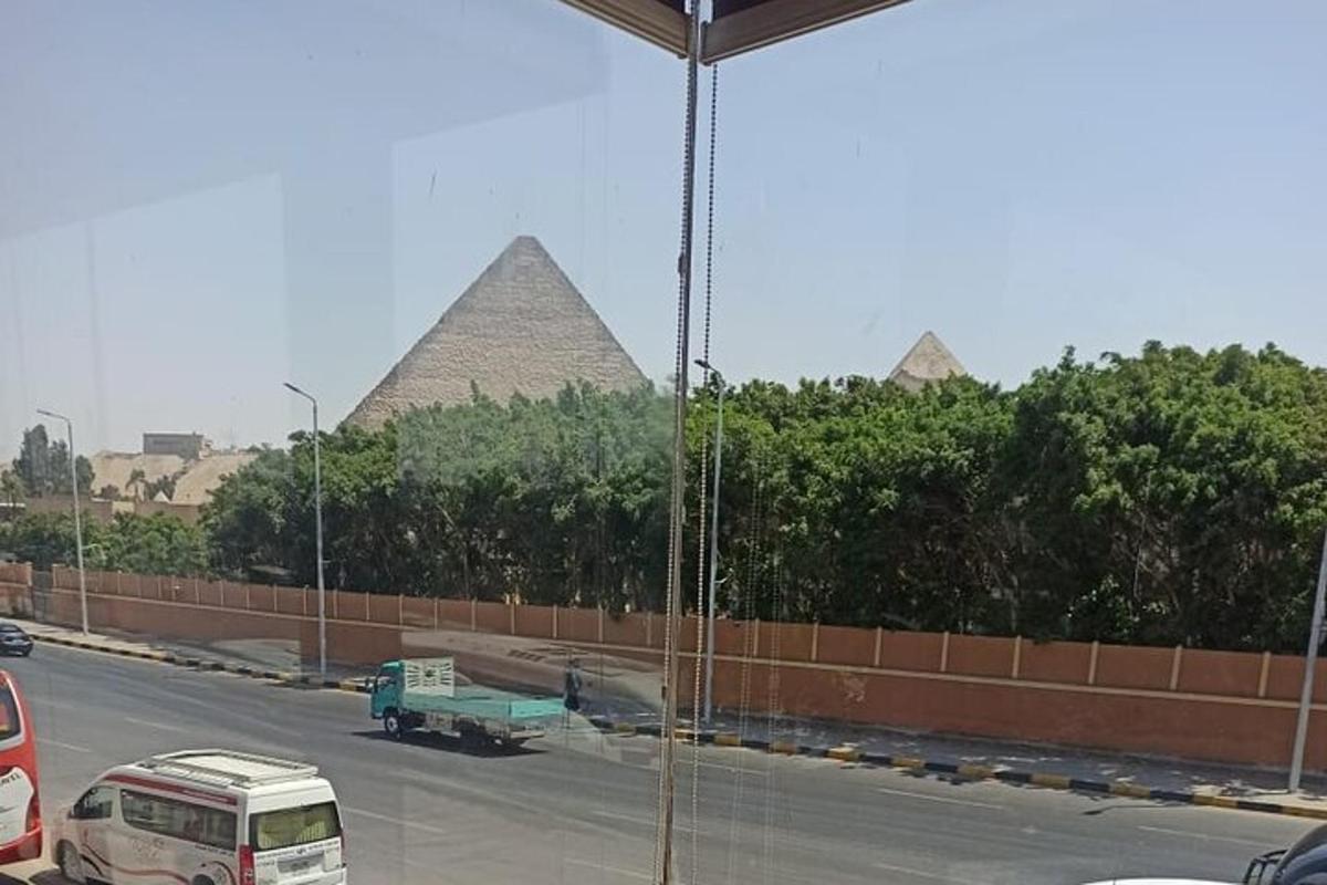 pohled na ulici s pyramidami v pozadí