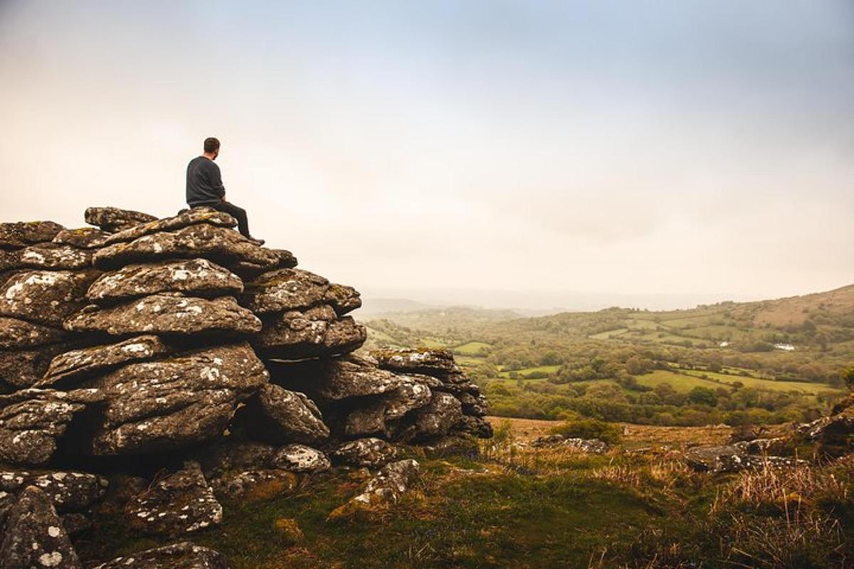 a man sitting on top of a pile of rocks