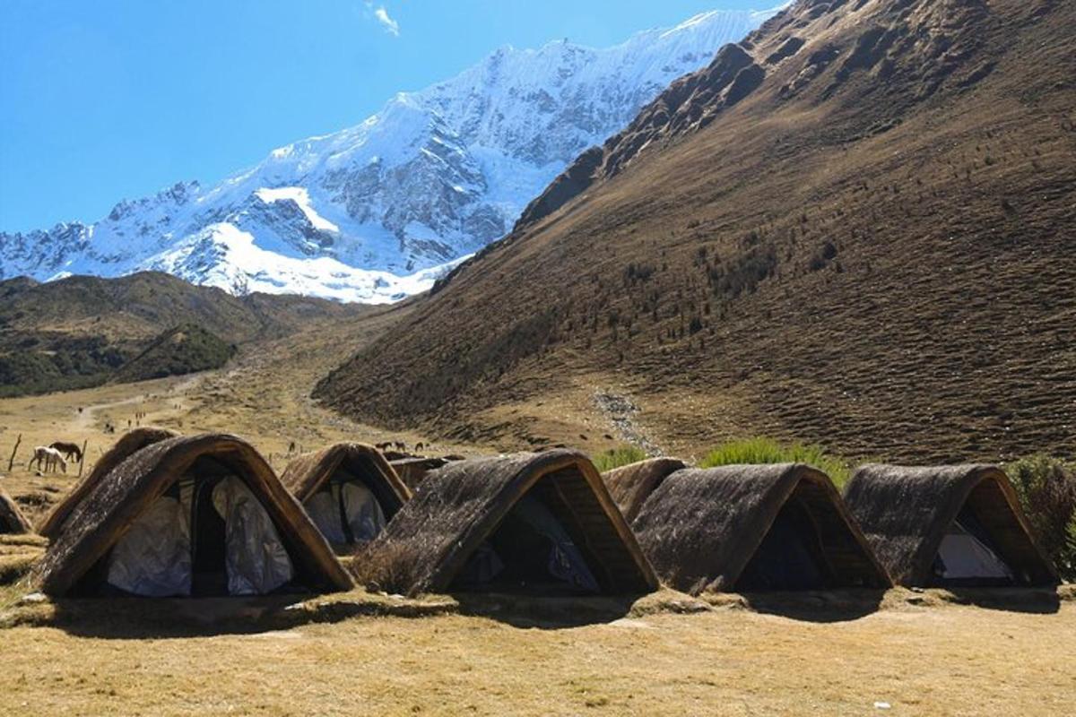 a group of tents on a mountain with snow