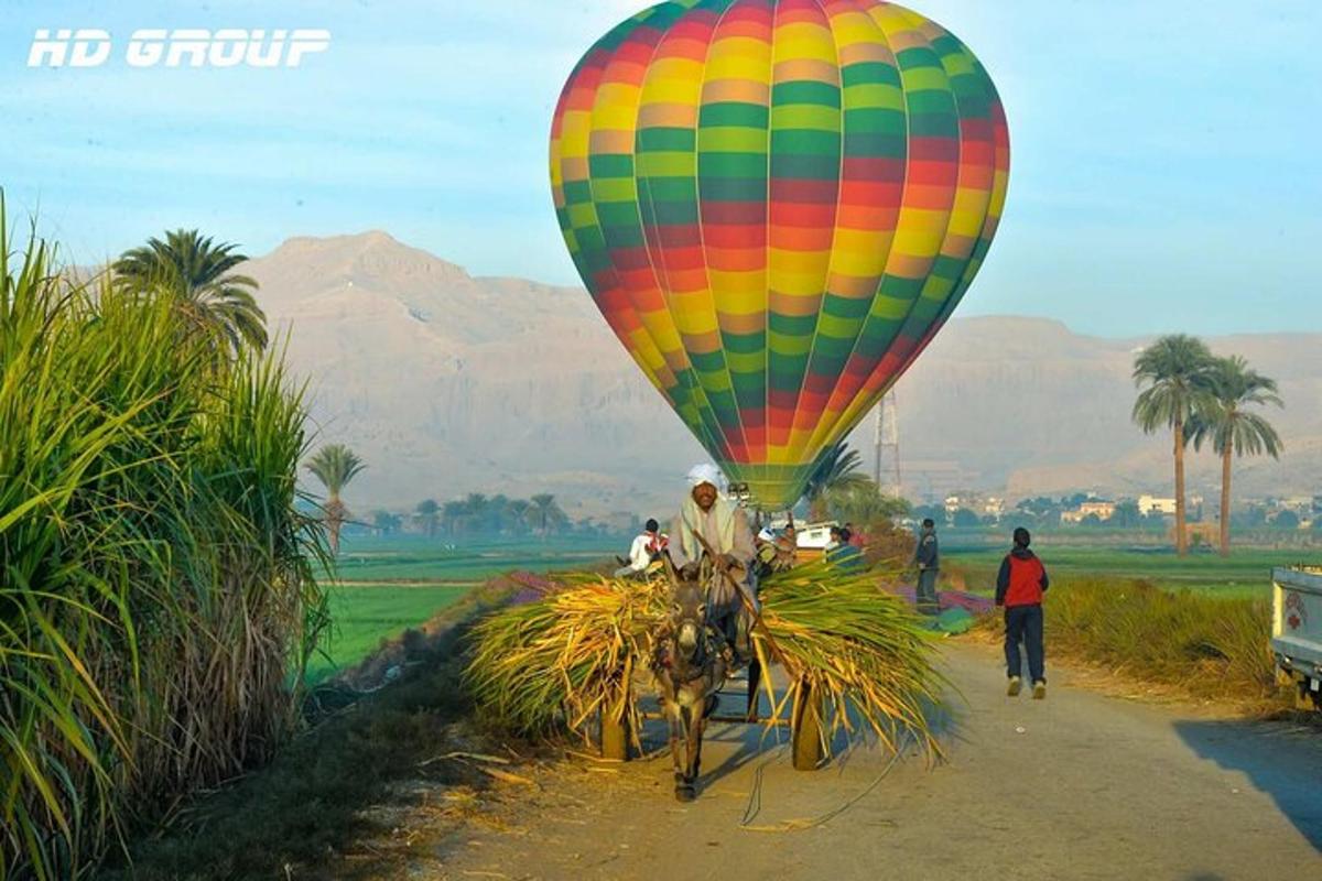 a colorful hot air balloon on a dirt road