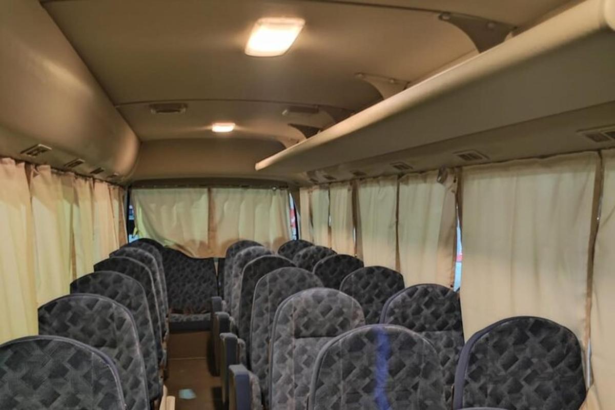 an empty train car with blue seats and curtains