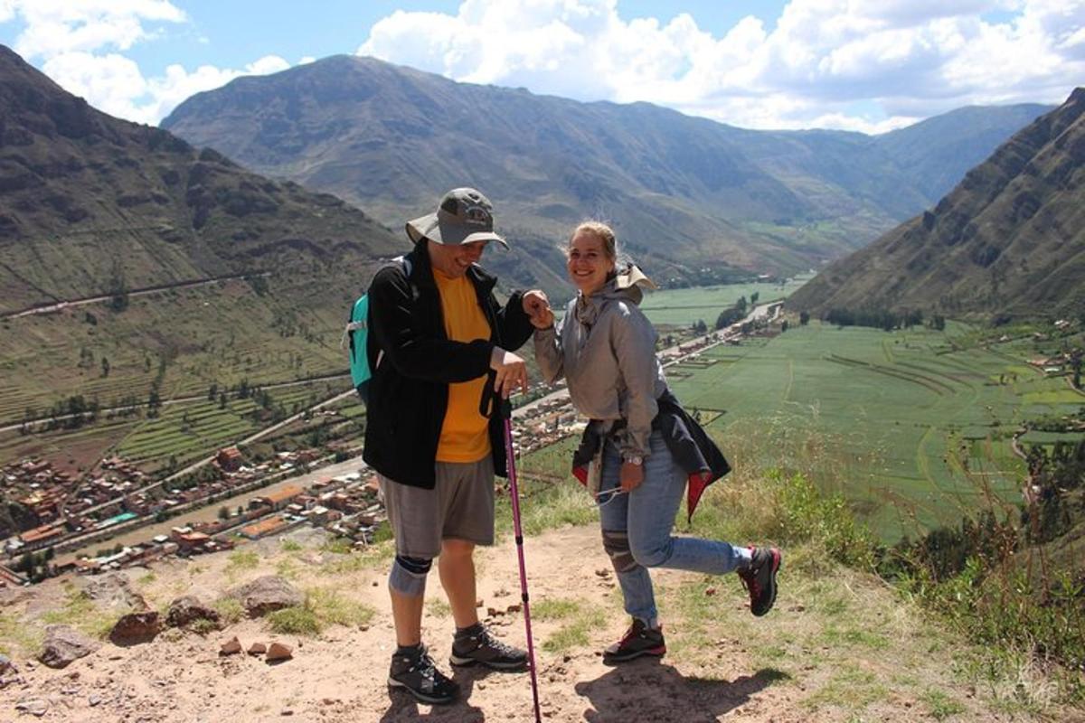 a man and woman standing on top of a mountain