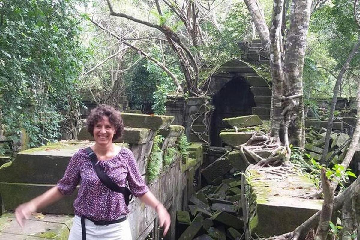 a woman standing in front of a stone tunnel