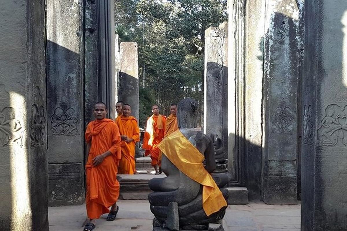 a group of men in orange robes standing in a building