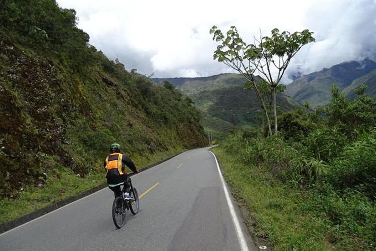 a man riding a bike down a road