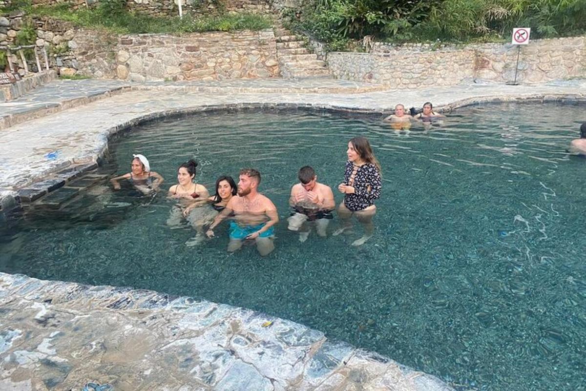 a group of people sitting in a swimming pool