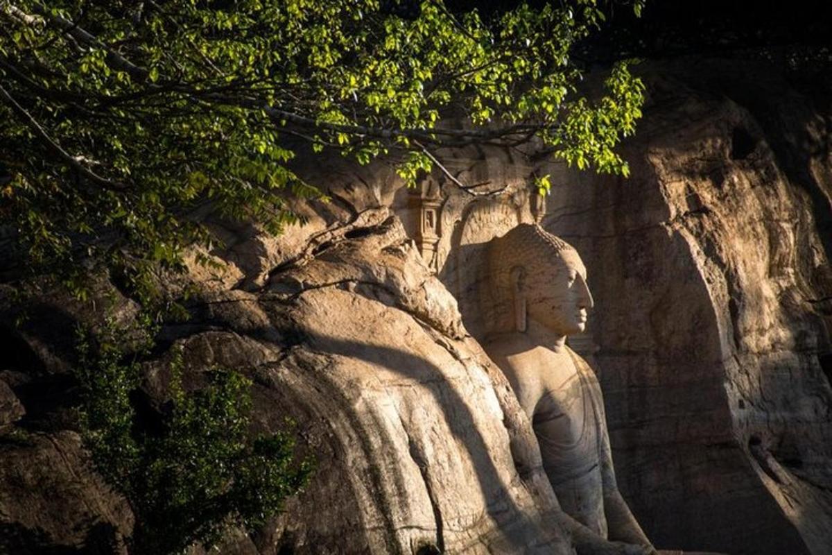 a statue sitting on the side of a mountain