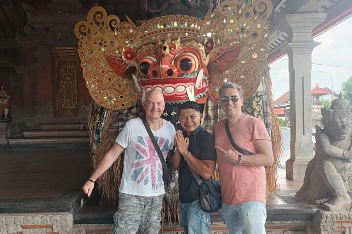 a group of three men standing in front of a temple