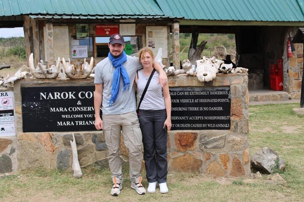 a man and a woman standing in front of a sign