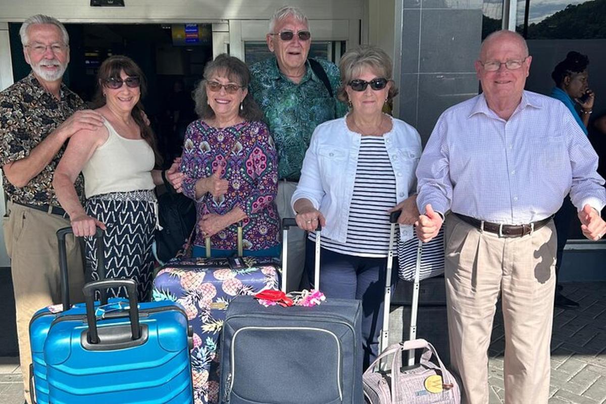 a group of people posing for a picture with their luggage