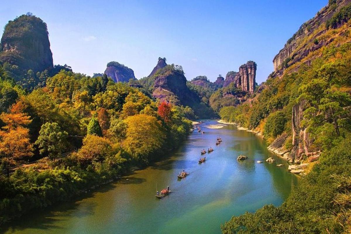a group of boats on a river in a canyon