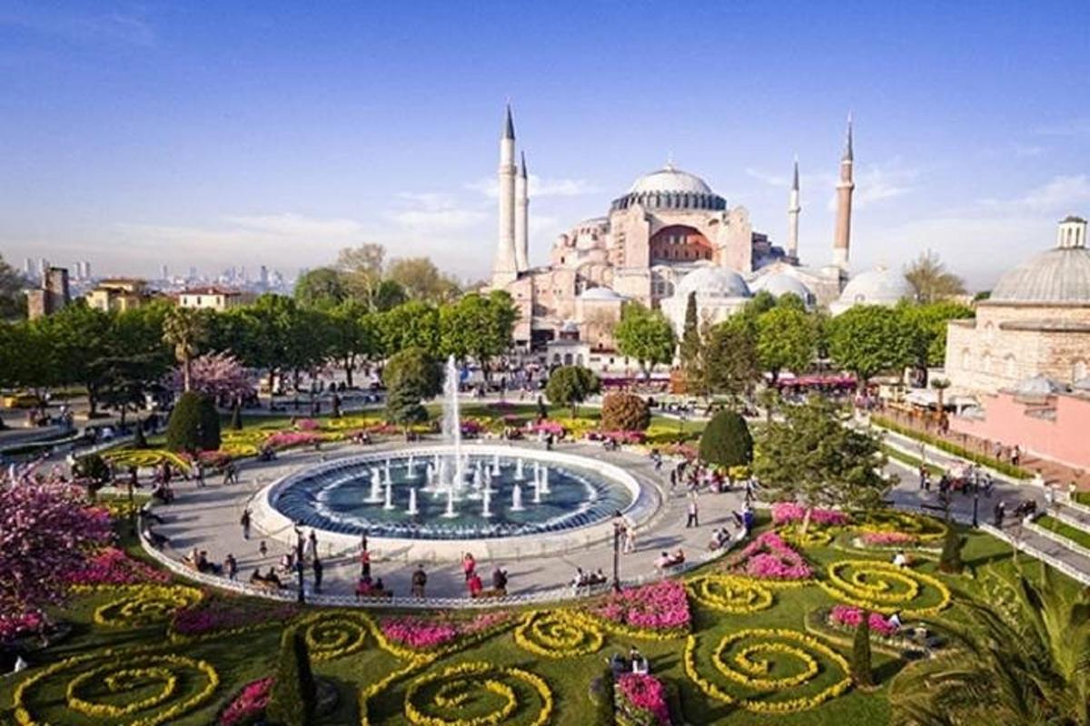 a view of a mosque with a fountain and gardens