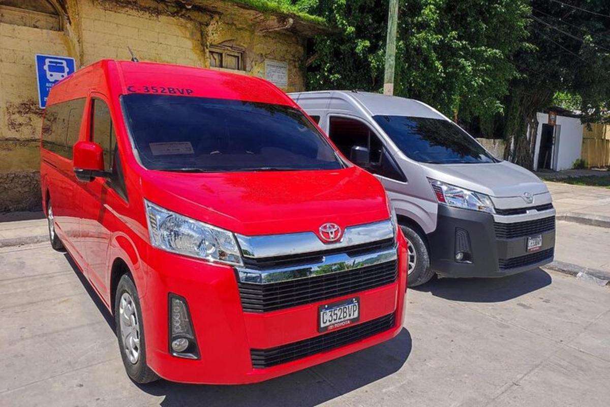 a red van and a silver van parked next to each other