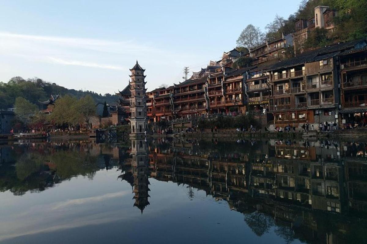 a reflection of buildings in a body of water