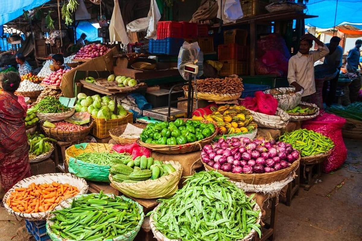 a market with baskets of fruits and vegetables on display