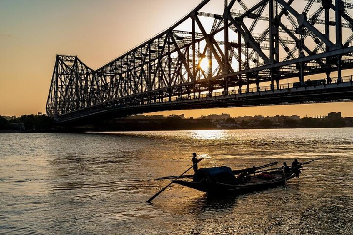 a boat in the water in front of a bridge
