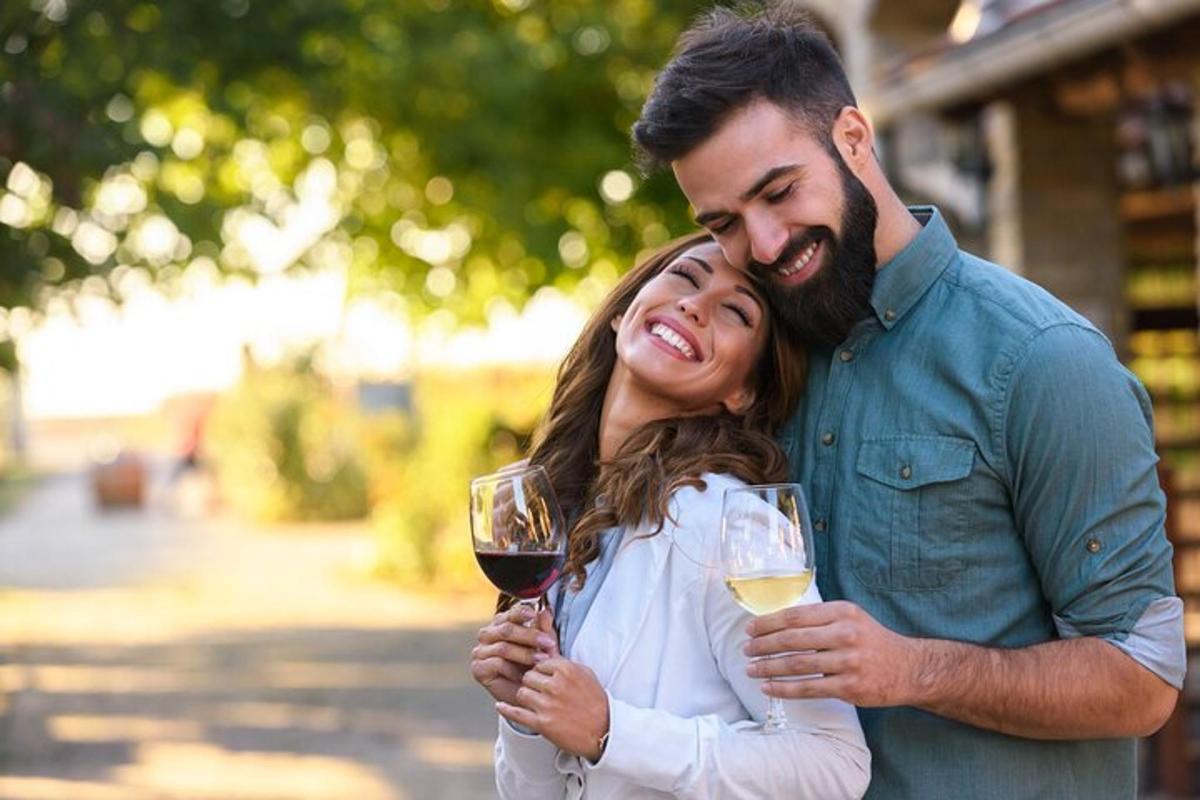 a man and a woman holding glasses of wine