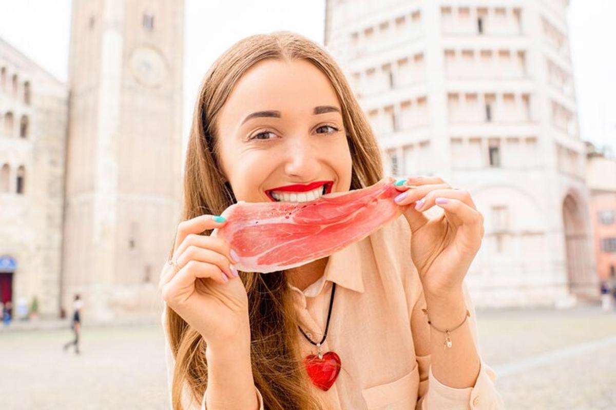 a woman holding a piece of meat in her mouth