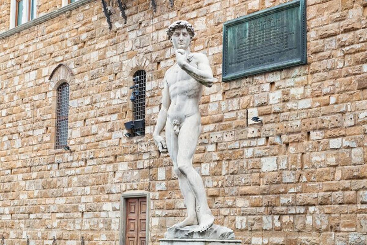 a statue of a man standing in front of a building