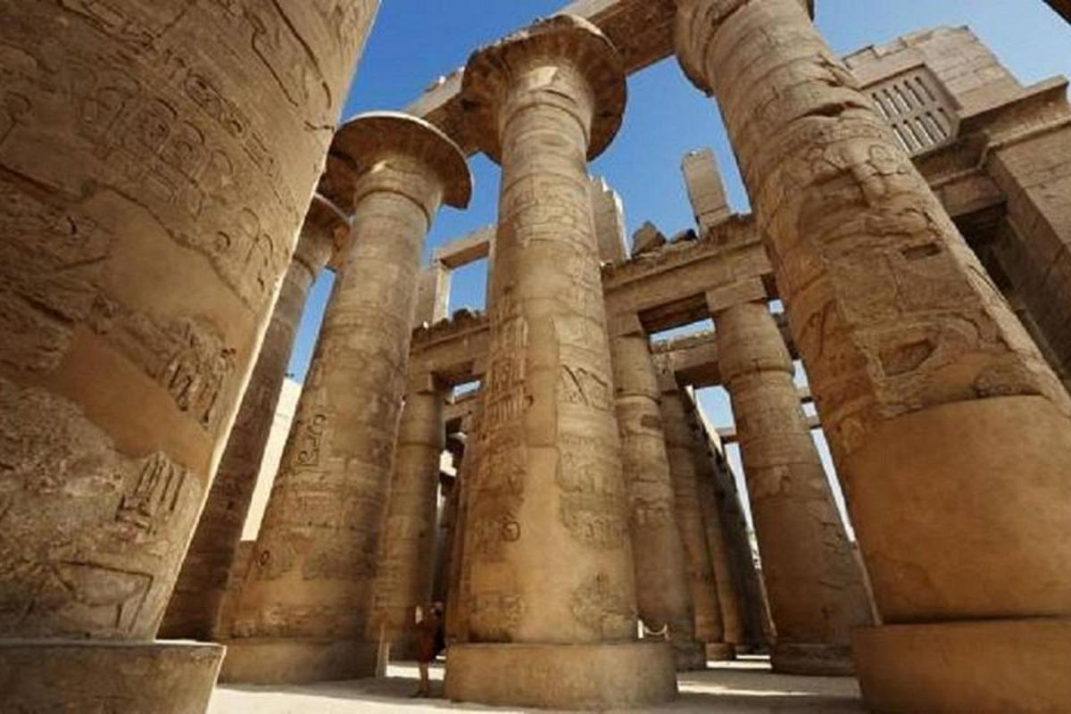 an ancient building with columns in a city