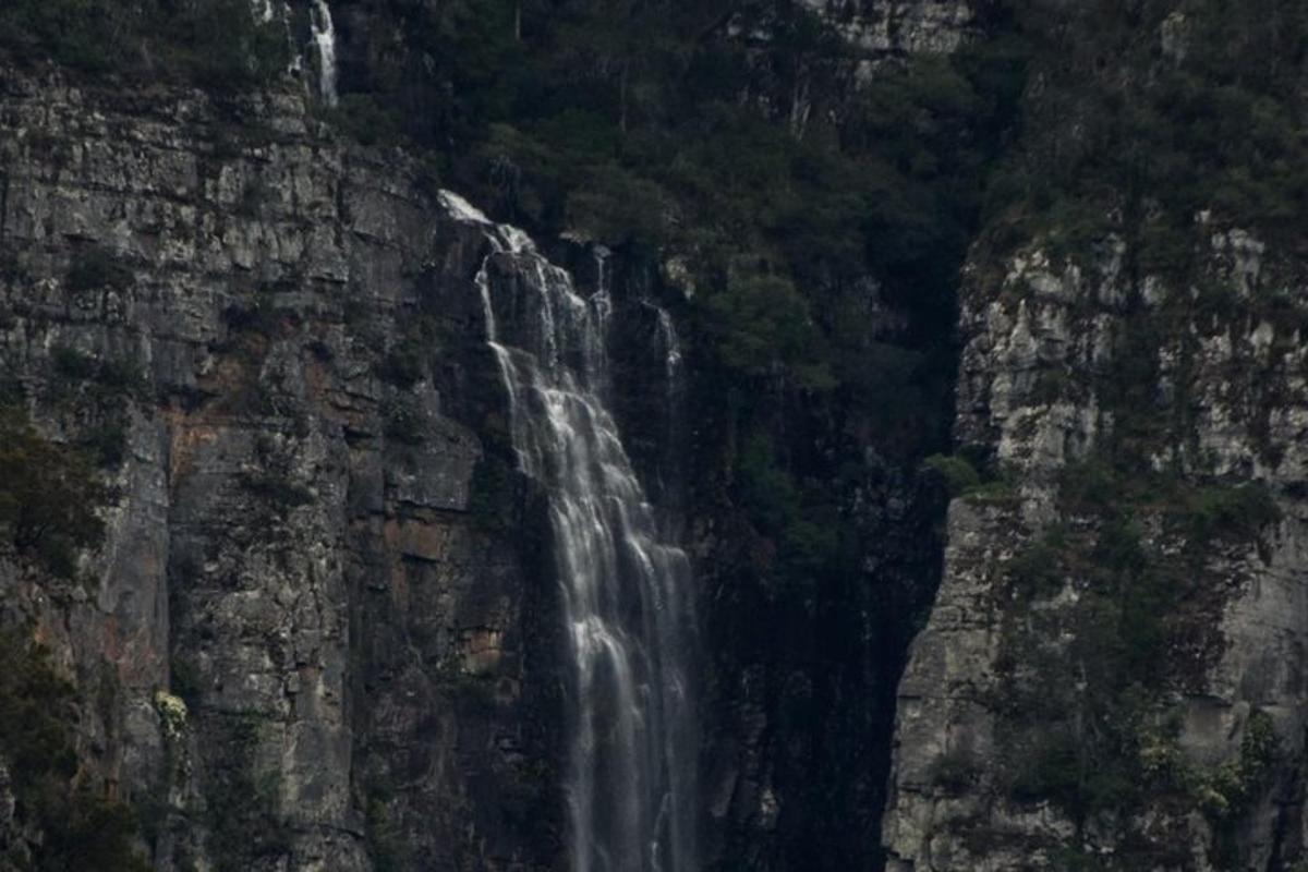 a waterfall on the side of a mountain