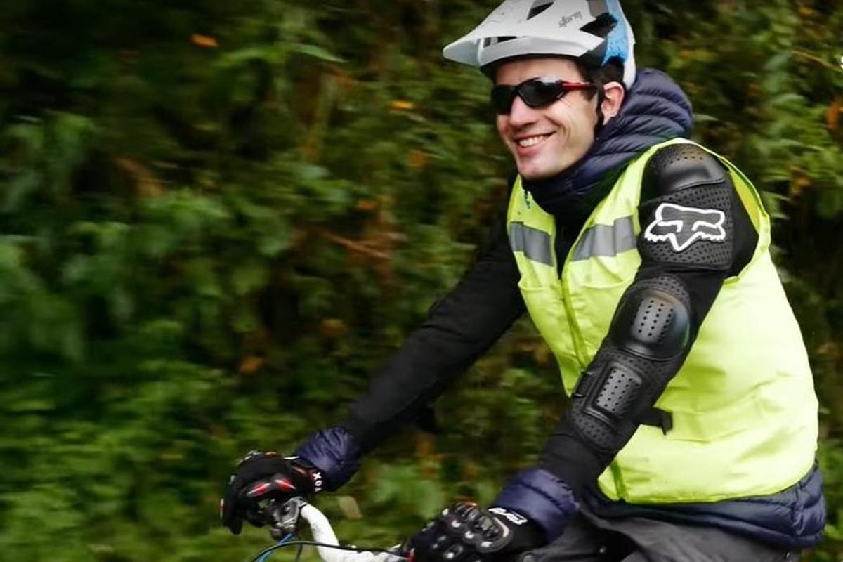 a man riding a bike with a helmet on
