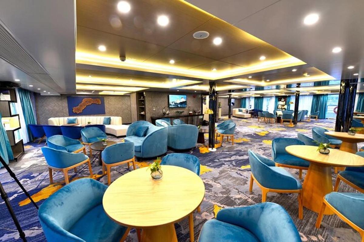 a waiting room on a cruise ship with tables and chairs