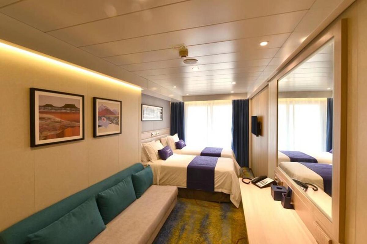 a hotel room with two beds and a couch