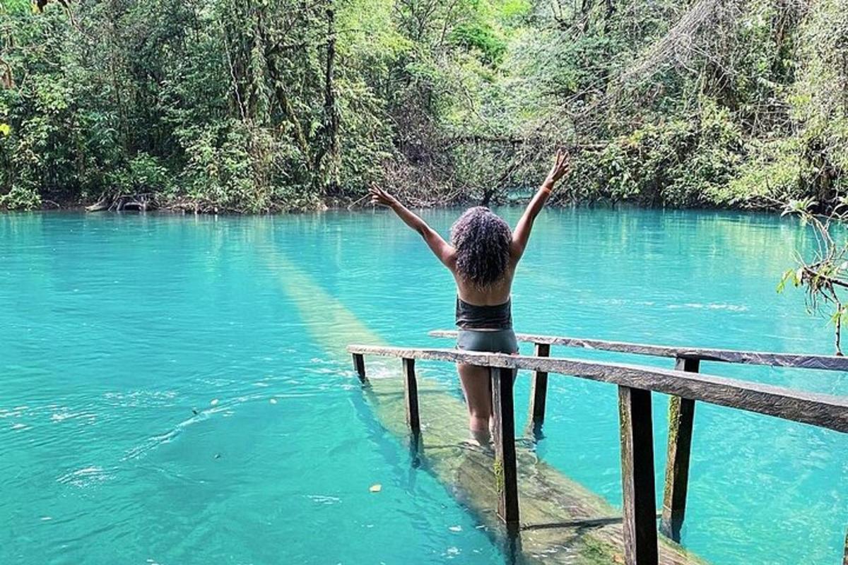 a woman standing in the water with her arms up