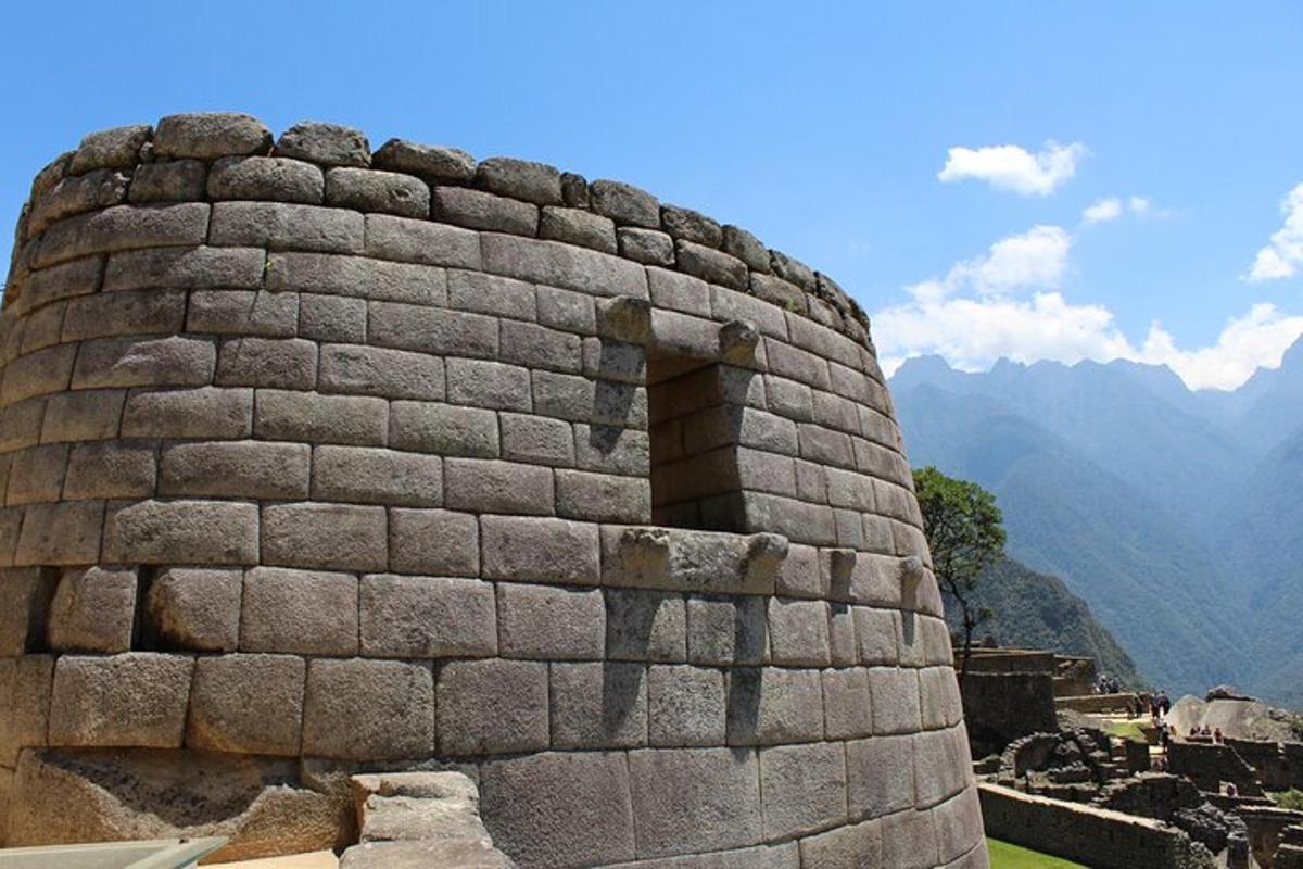 a stone wall with a window on top of a mountain