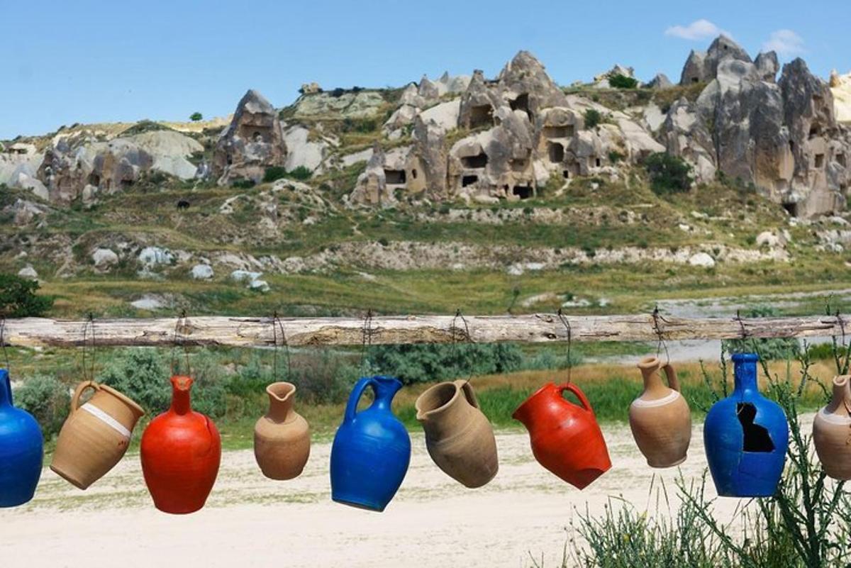 a group of different colored vases sitting on the ground
