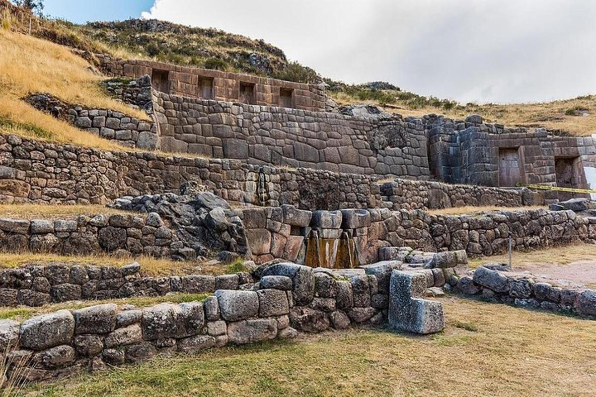 an old stone building on the side of a hill