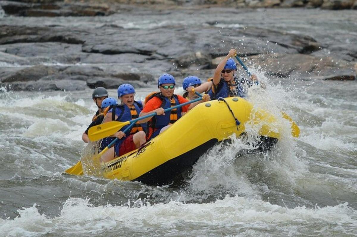 a group of people in a raft in the water