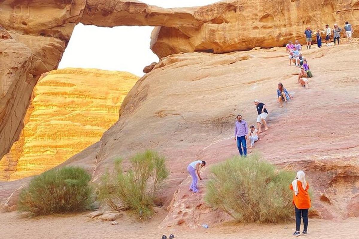 un grup de persones pujant un turó al desert