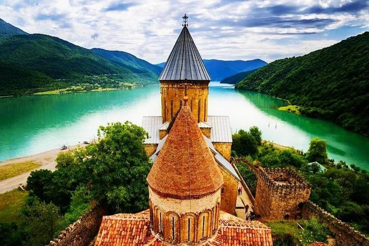 a building with a tower next to a body of water