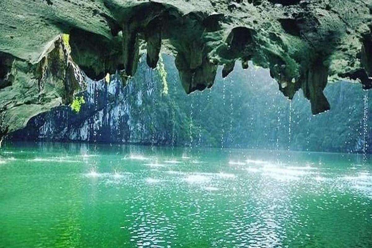 a pool of green water in a cave