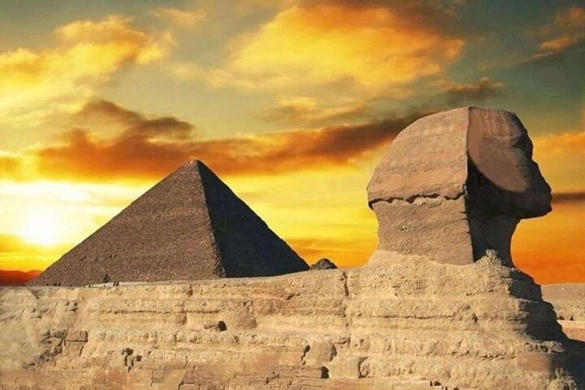 an image of the sphinx and pyramid at sunset