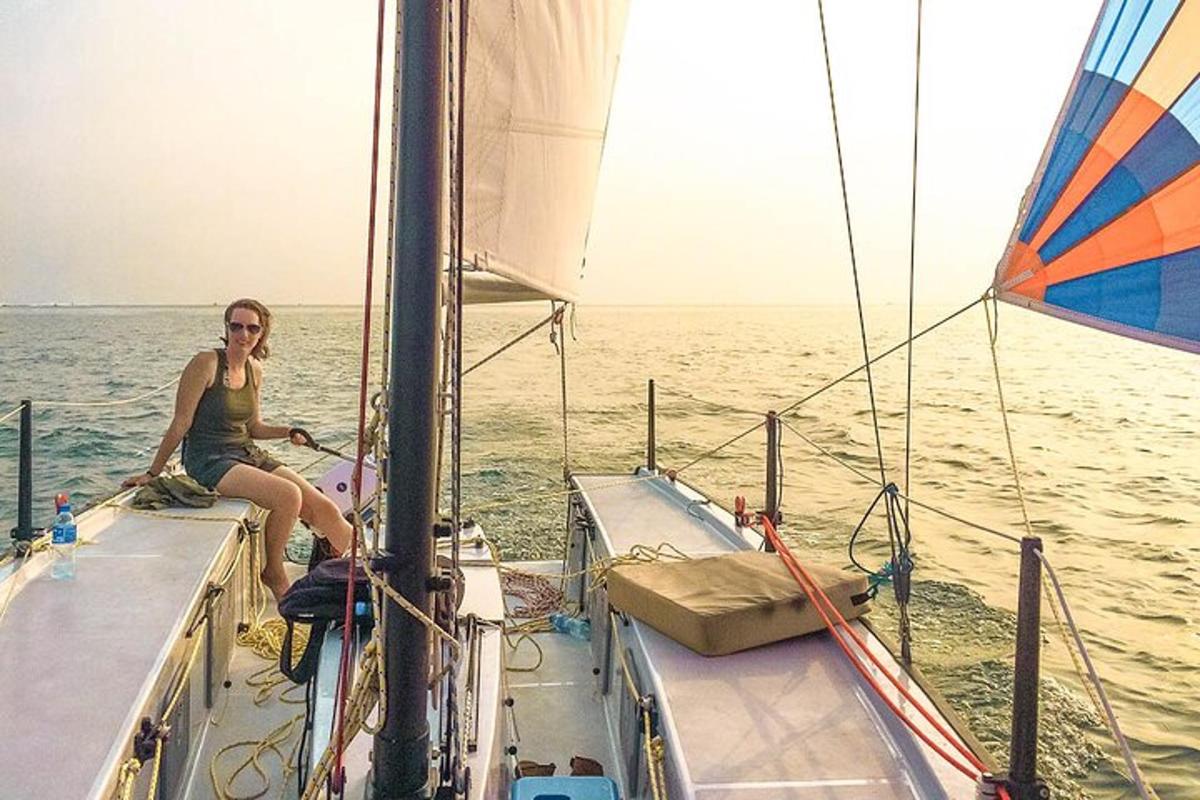 a woman sitting on a sail boat in the ocean